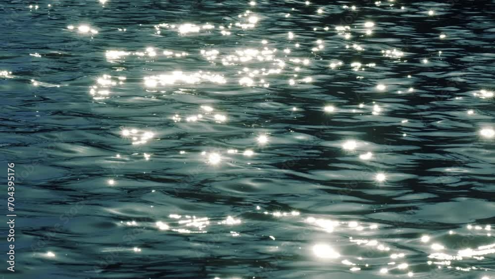 Slow motion of golden glittering sea surface, abstract background.