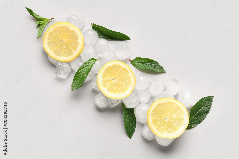 Lemon slices with ice cubes and mint on white background Lemon slices with ice cubes and mint on white background