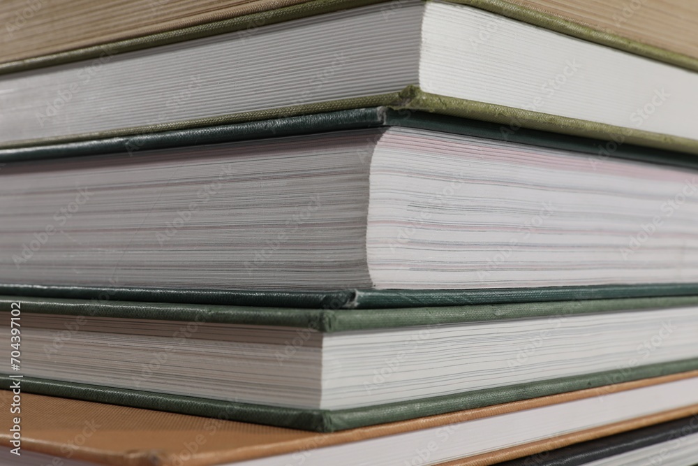 Stack of many different hardcover books as background, closeup Stack of many different hardcover books as background, closeup