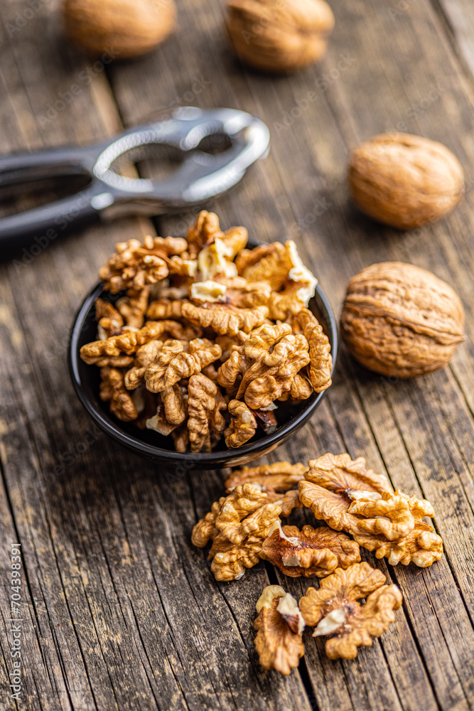 Peeled dried walnut kernels on wooden table. Peeled dried walnut kernels on wooden table.