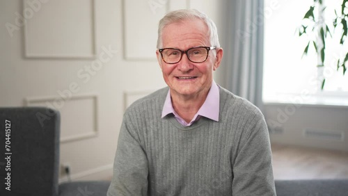 Portrait of confident stylish European middle aged senior man at home. Older mature 70s man smiling. Happy attractive senior grandfather looking camera close up face headshot portrait. Happy people photo