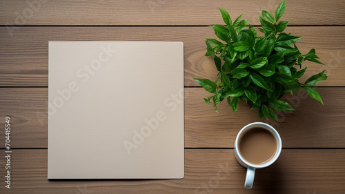 a notebook coffee card and plant on wooden table