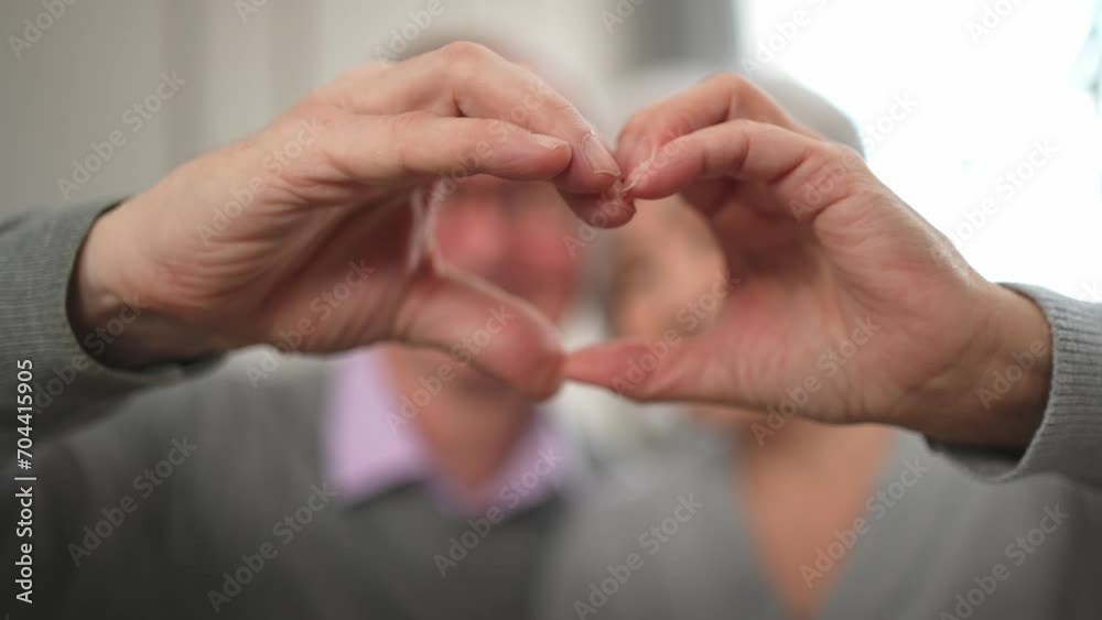 Love heart shape peace. Senior older couple making heart shape with their hands. Adult mature old husband wife showing heart sign. Happy pensioner family. I love you happy valentines day Love heart shape peace. Senior older couple making heart shape with their hands. Adult mature old husband wife showing heart sign. Happy pensioner family. I love you happy valentines day