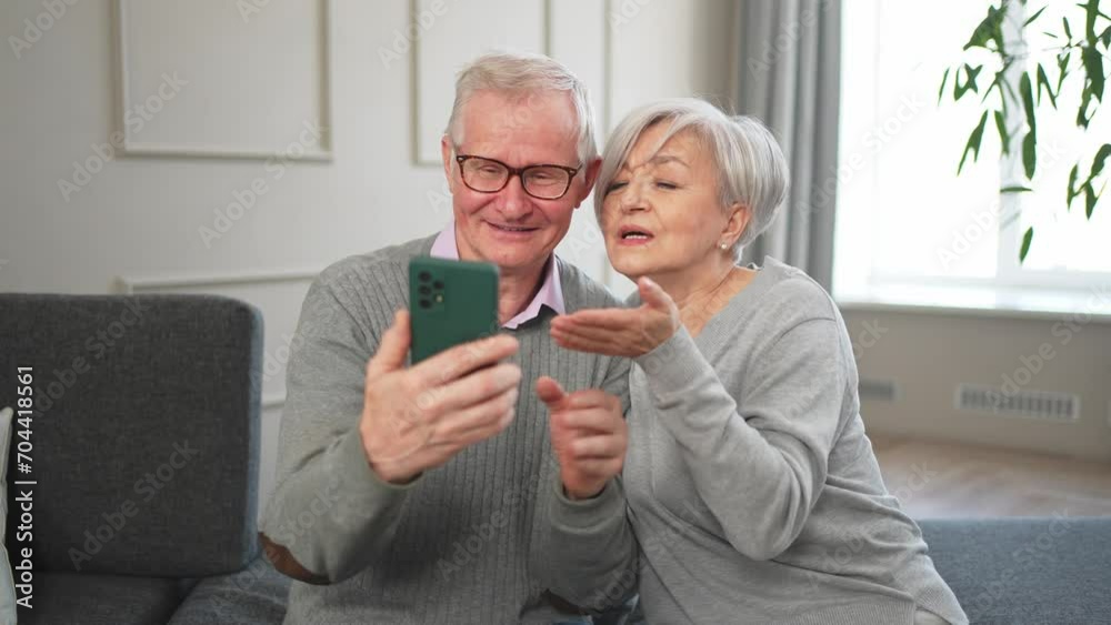 Video call. Happy senior couple woman man with smartphone having video call. Mature old grandmother grandfather talking speaking online. Older generation modern tech usage. Virtual meeting online chat Video call. Happy senior couple woman man with smartphone having video call. Mature old grandmother grandfather talking speaking online. Older generation modern tech usage. Virtual meeting online chat