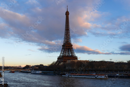 View of Eiffel Tower and river Seine at sunset in Paris. Eiffel Tower is one of the most iconic landmarks of Paris © kovalenkovpetr