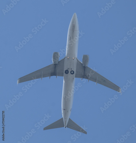 Low angle view of Airplane flying under blue sky