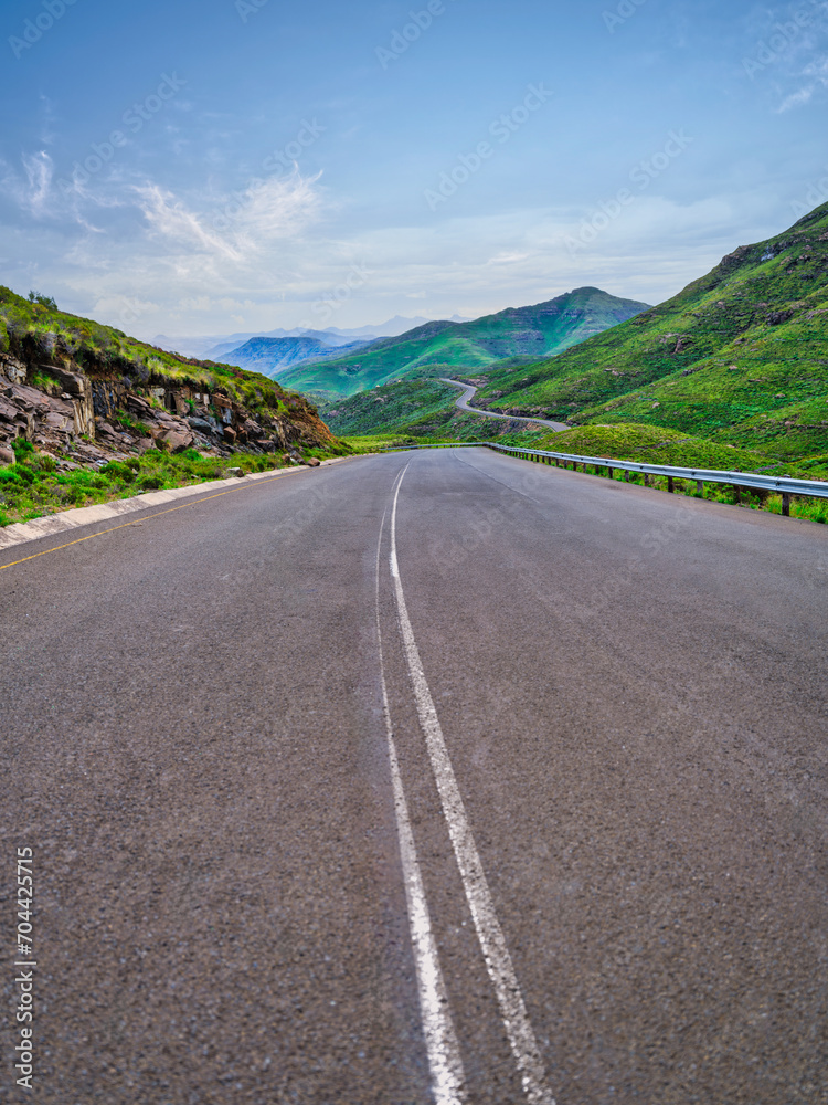 Vertical shot of a highway through a gorge surrounded by mountains in the highlands of Lesotho