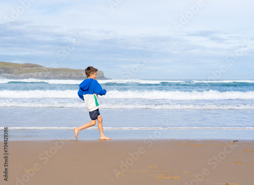 Boy running along the seashore