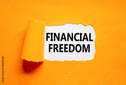 Financial freedom symbol. Concept words Financial freedom on beautiful white paper. Beautiful orange paper background. Business financial freedom concept. Copy space.