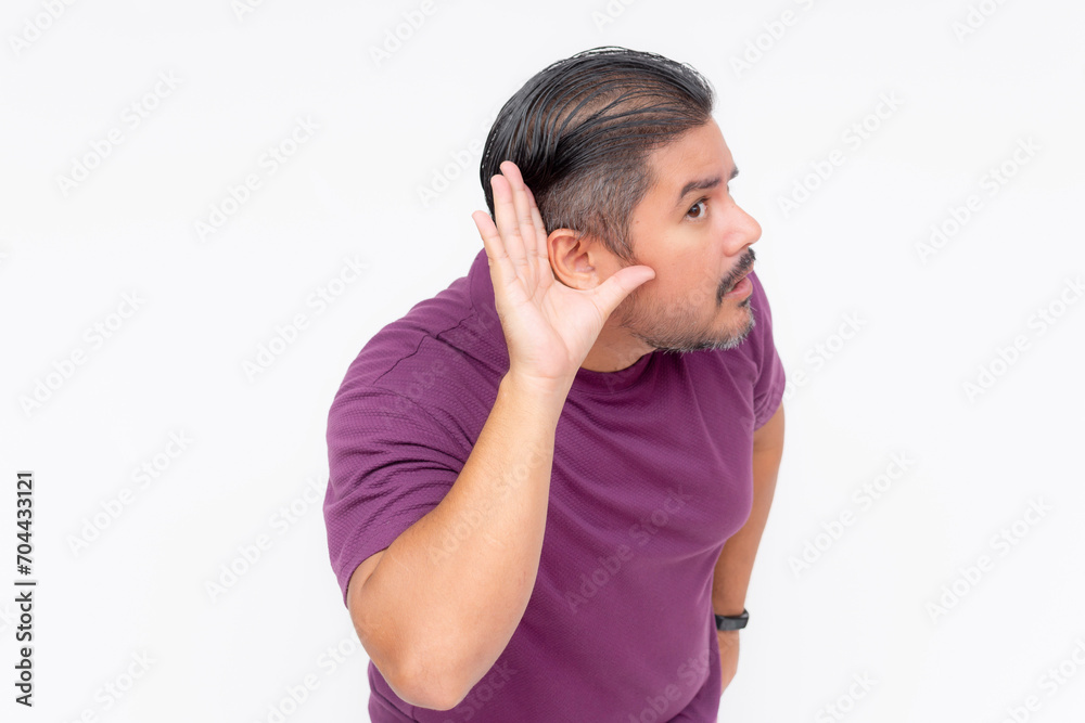 A middle aged man leaning forward and gesturing with his hand on his ear to speak louder. Having trouble hearing. Isolated on a white background. A middle aged man leaning forward and gesturing with his hand on his ear to speak louder. Having trouble hearing. Isolated on a white background.