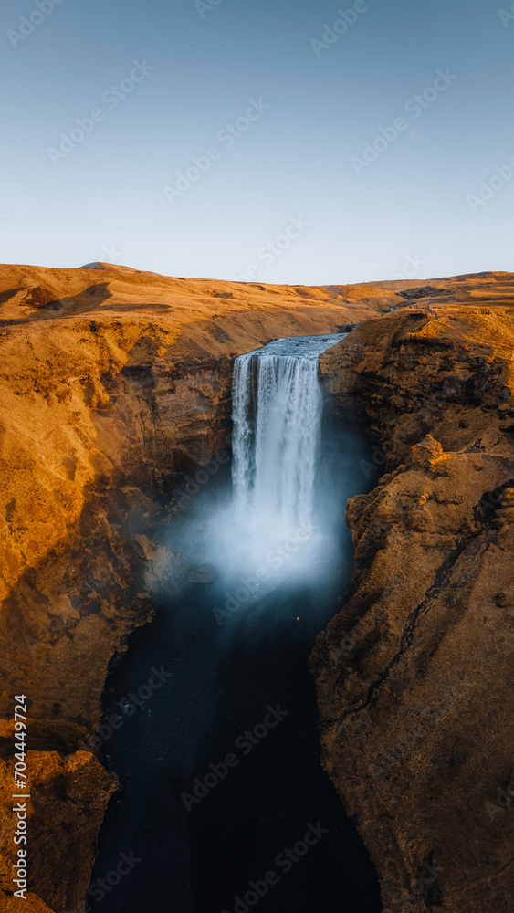 Iceland. Aerial view on the Skogafoss waterfall. Landscape in the Iceland from air. Famous place in Iceland. Landscape from drone. Travel concept. Sunset and sunrise. Soft light.