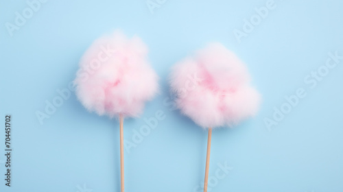 sticks with yummy cotton candy on blue background