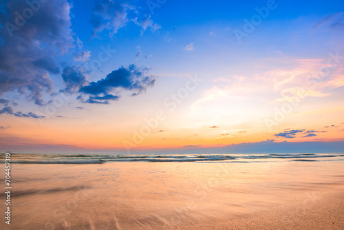 Calm seascape with a beautiful sunset sky and fluffy clouds.