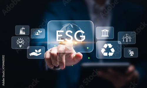 ESG environmental, social and governance. Businessman touching virtual global ESG icons for world sustainable environment concept. social business strategy, environment, business investment strategy.
