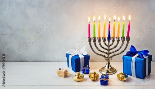 hanukkah celebration menorah with burning candles dreidels and gift boxes on white table space for text