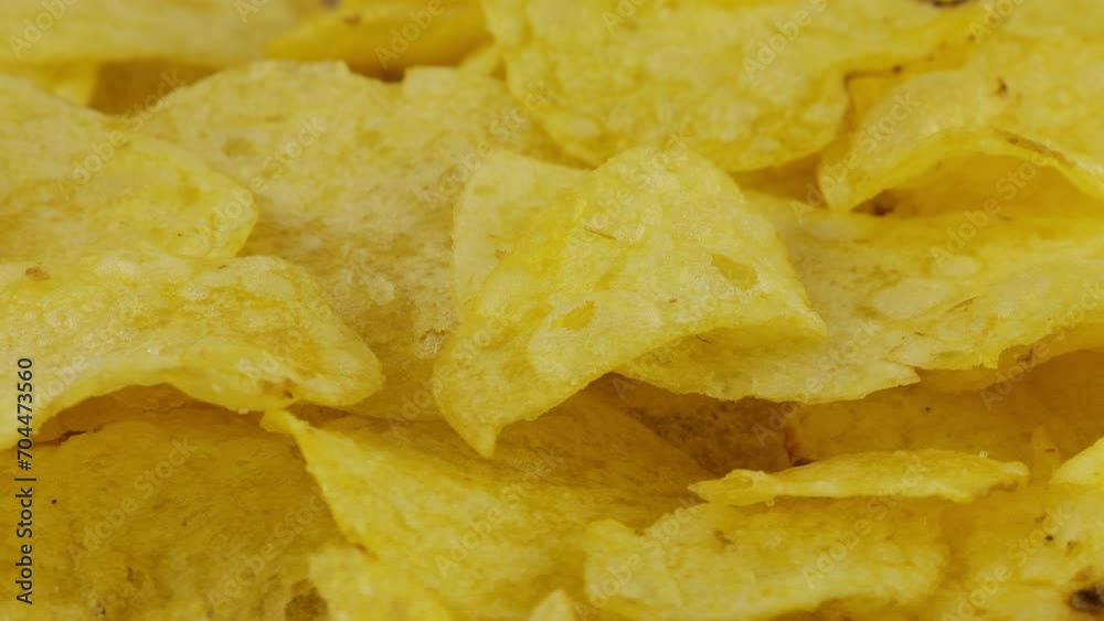 Potato chips rotating close up on culinary parchment. Potato chips rotating close up on culinary parchment.