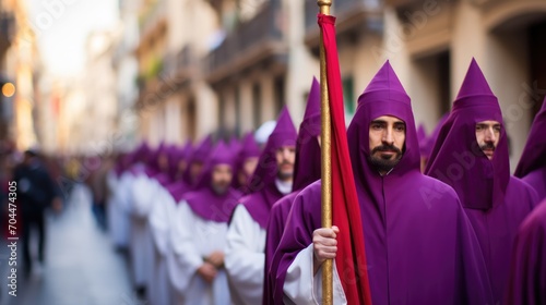Holy Week , group of penitents holding a cross dresses  with vivid colors. photo