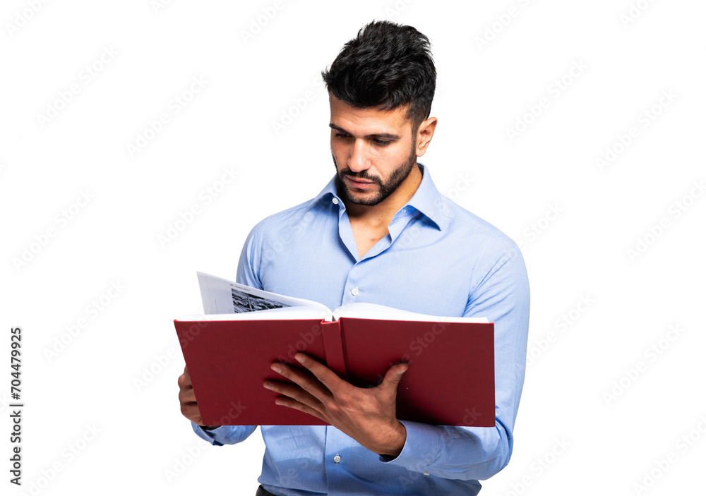 Young man intently reading a red book Young man intently reading a red book