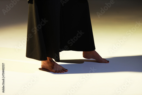 Concept of female feet and dress and shadows