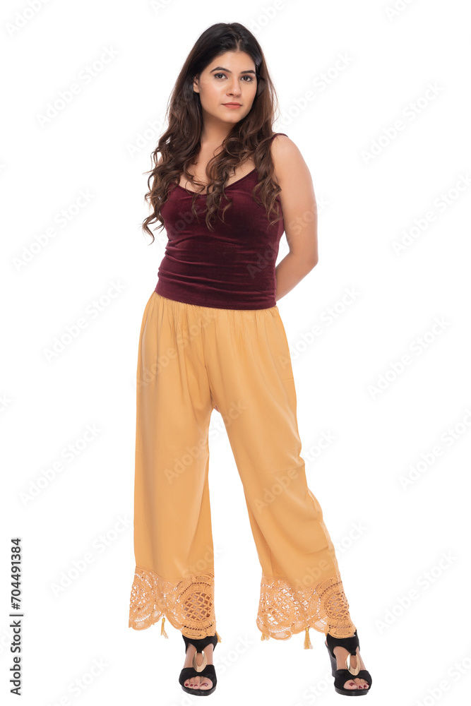 Young Indian girl wearing red velvet top and yellow lacy pants with elegant pose and expression Young Indian girl wearing red velvet top and yellow lacy pants with elegant pose and expression
