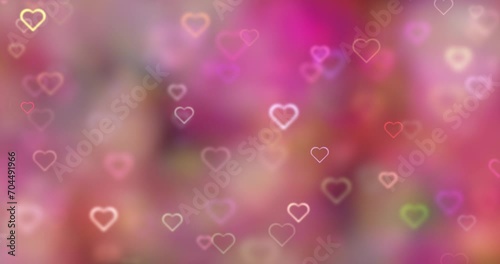 Blurred soft pink bokeh with glowing heart symbols loop motion background. Valentine's day holidays copy space greeting card.