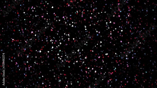 Colorful small hearts slow motion movement on clean black loop background. Valentine's day holidays copy space greeting card.