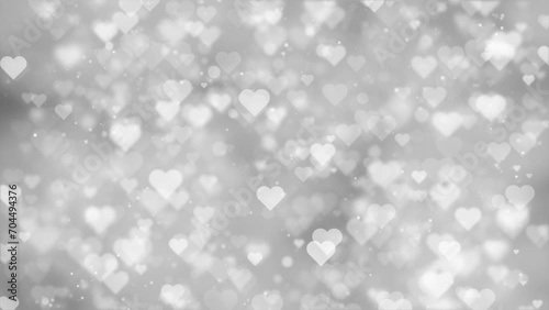 White glowing heart symbols loop motion on silver bokeh background. Valentine's day holidays copy space greeting card.