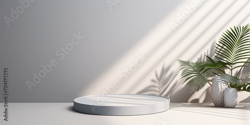 White table and abstract geometric wall with floral and palm leaf shadows. Gray studio for presenting products. room with room for text. Summer idea.