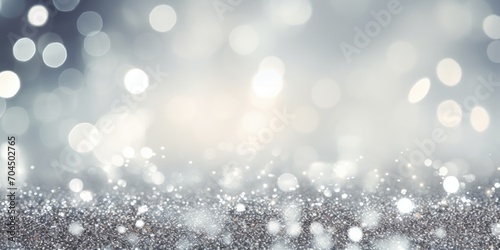 Shiny silver white abstract blurred bokeh lights background. Festive glitter sparkle background 