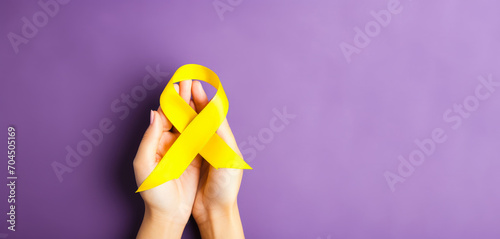 yellow Ribbon against white background for endometriosis awareness campaign, suicide prevention , Childhood cancer. photo
