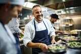 A portrait of male chef, smiling and having fun in a modern commercial kitchen while cooking a dish, 