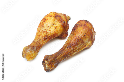 Two roasted and marinated chicken drumstick thigh legs isolated on white background