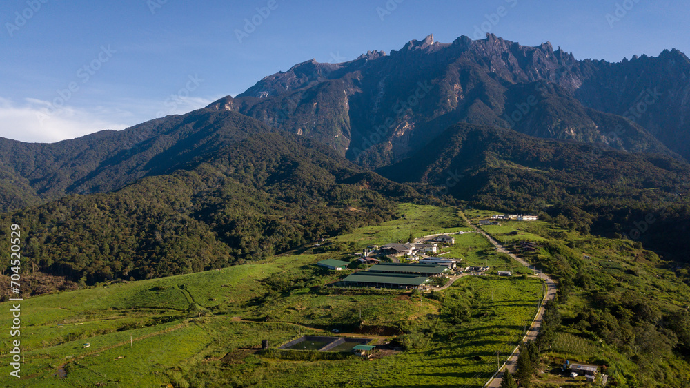 View of a small village located at the base of towering mountains