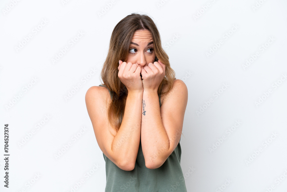 Young caucasian woman isolated on white background nervous and scared putting hands to mouth Young caucasian woman isolated on white background nervous and scared putting hands to mouth