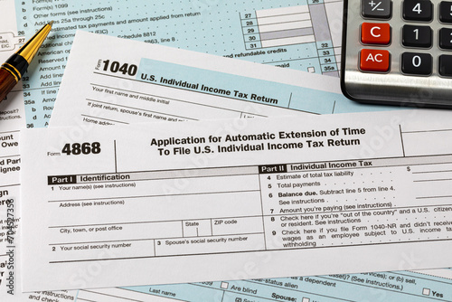 Form 4868 automatic filing extension for federal income taxes. Income tax return filing deadline, delay and penalty concept.  photo