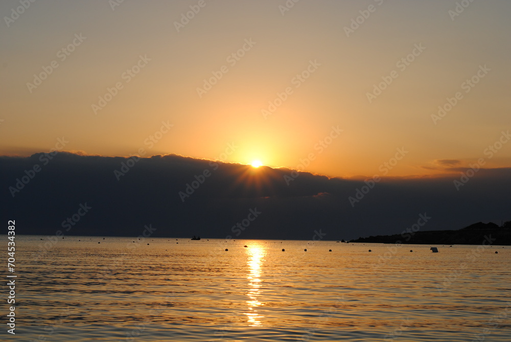 sunset at the beach beyond clouds and sea sunset at the beach beyond clouds and sea