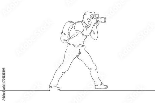 Fototapeta Naklejka Na Ścianę i Meble -  Photographer on the set. Photographer with a camera in his hands. The cameraman is filming. One continuous line drawing. Linear. Hand drawn, white background. One line