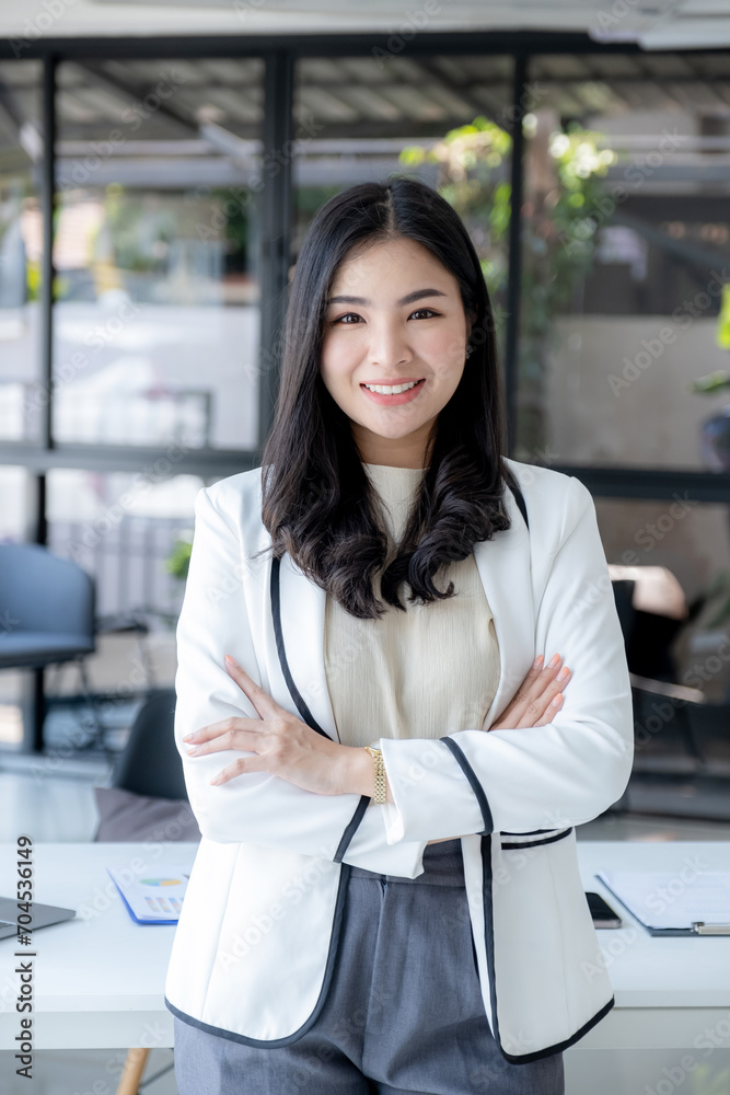 Businesswomen management stand and plans strategies to increase business income. Have a working finance graph analysis and discuss the new target success Businesswomen management stand and plans strategies to increase business income. Have a working finance graph analysis and discuss the new target success