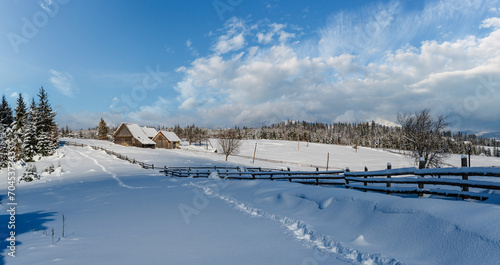 Countryside hills, groves and farmlands in winter remote alpine mountain village © wildman
