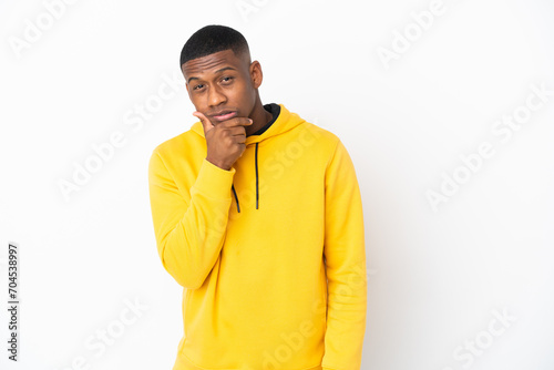 Young latin man isolated on white background having doubts