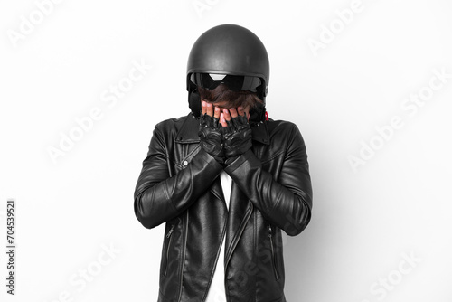 Young man with a motorcycle helmet isolated on white background with tired and sick expression