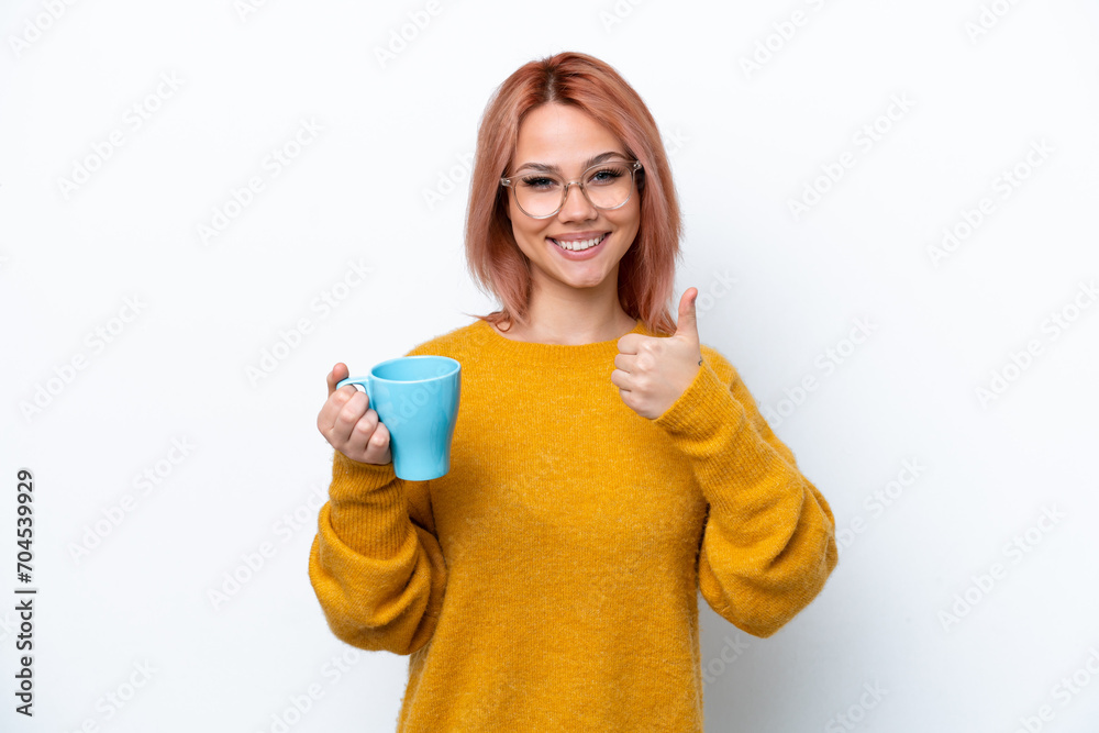 Young Russian girl holding cup of coffee isolated on white background with thumbs up because something good has happened Young Russian girl holding cup of coffee isolated on white background with thumbs up because something good has happened