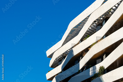 Detail of the white facade of a modern apartment building in the city of Madrid in Spain photo