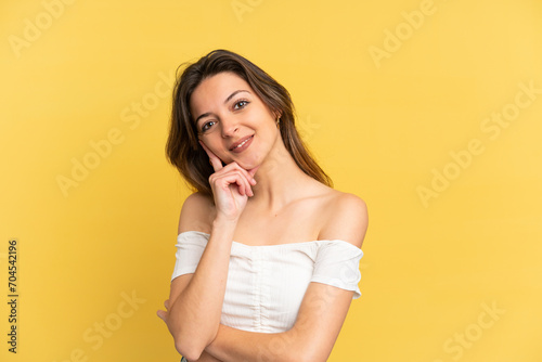 Young caucasian woman isolated on yellow background happy and smiling