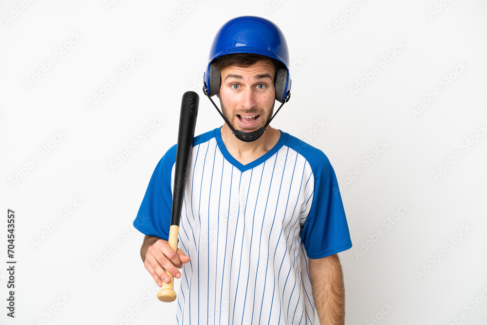Young caucasian man playing baseball isolated on white background with surprise facial expression