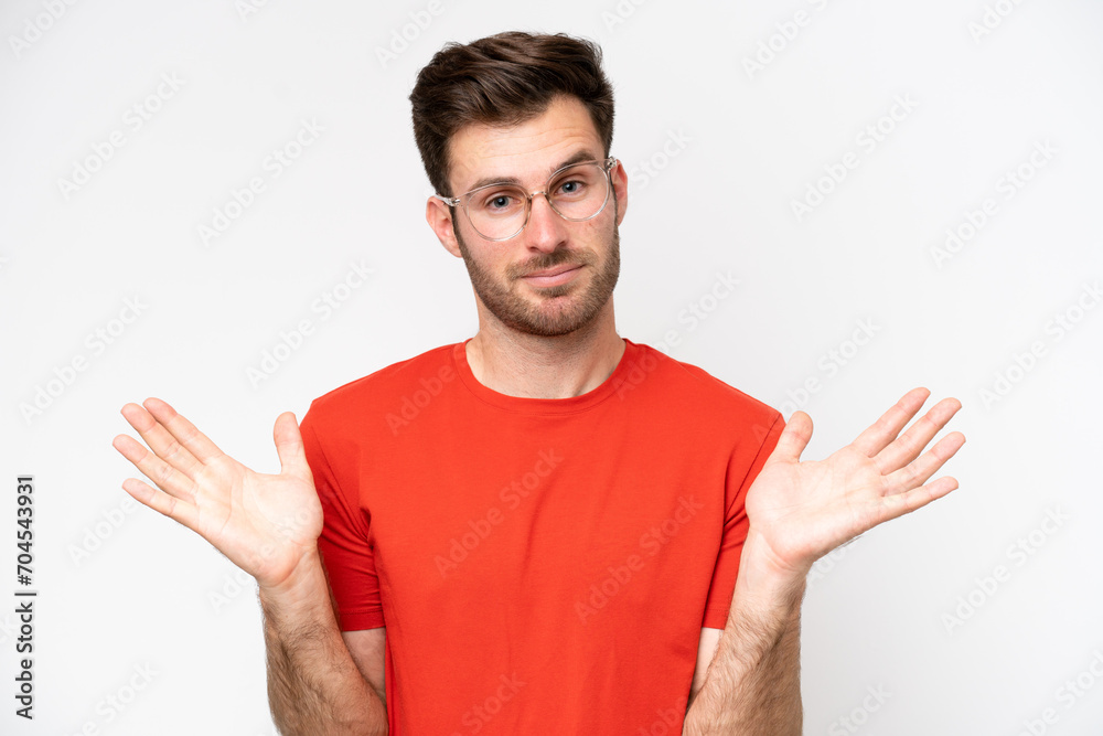 Young caucasian man isolated on white background With glasses and having doubts Young caucasian man isolated on white background With glasses and having doubts