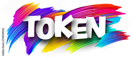 Token paper word sign with colorful spectrum paint brush strokes over white.