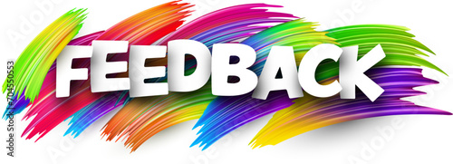 Feedback paper word sign with colorful spectrum paint brush strokes over white.