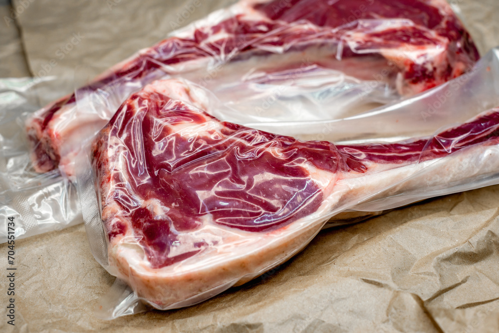 Obraz premium fresh beef in vacuum packaging on a background of kraft paper