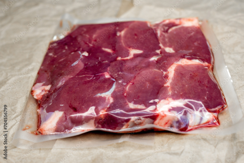 fresh beef in vacuum packaging on a background of kraft paper fresh beef in vacuum packaging on a background of kraft paper